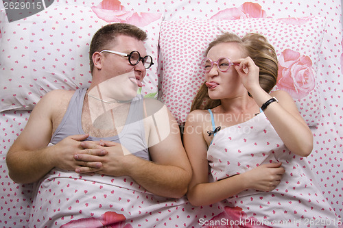 Image of young pair of glasses lying in bed