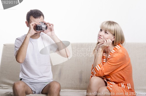 Image of Guy photographed her sitting on the couch