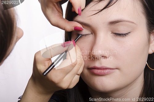 Image of Makeup artist colors eyelashes model