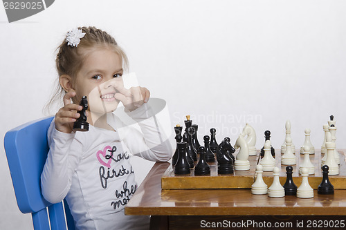 Image of Girl toying playing chess