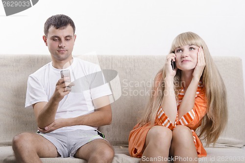 Image of Girl on phone, guy writes SMS