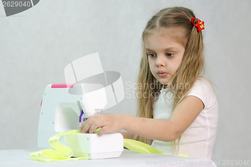 Image of Girl sewing on the machine