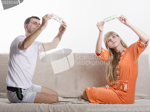 Image of Young boy and girl define fake whether banknotes