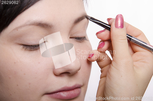 Image of Makeup artist brings eyebrow pencil model