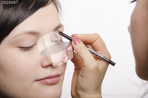 Image of Makeup artist brings eyebrow pencil model