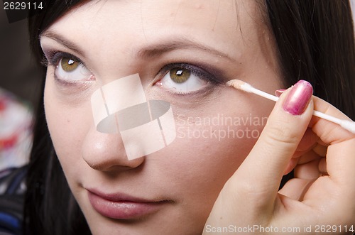 Image of Makeup artist colors upper eyelids model