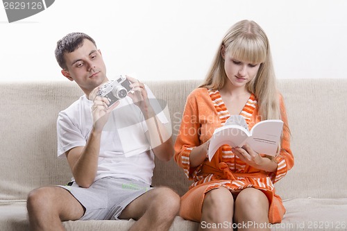 Image of Young couple versed with the device camera