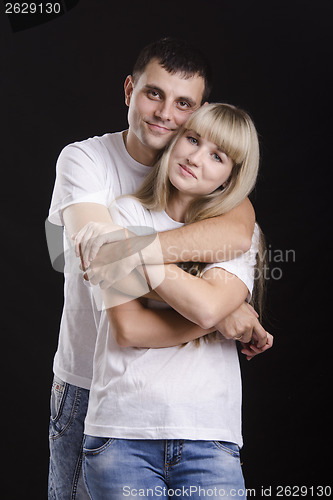 Image of Portrait of a young couple on black background
