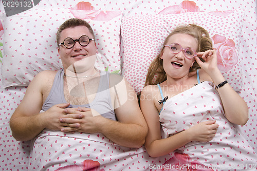 Image of young pair of glasses lying in bed