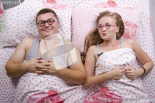 Image of young pair of glasses lying in bed