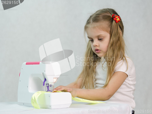 Image of Girl sewing on the machine