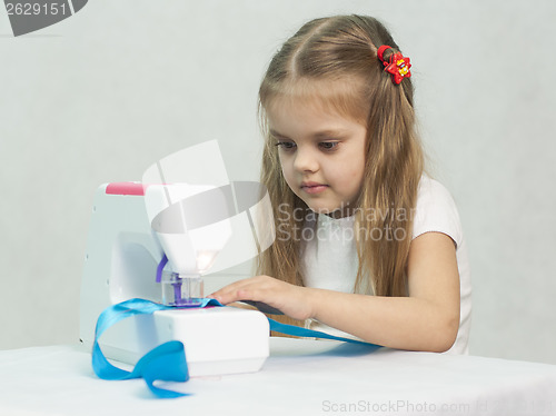 Image of Girl sewing on the machine