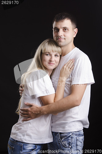 Image of Portrait of a young couple on black background