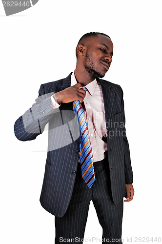 Image of Black man taking off tie.