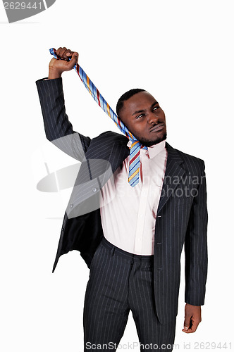 Image of Black man pulling his tie.