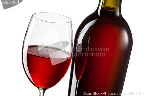 Image of Glass of red wine and bottle isolated on white