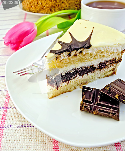 Image of Cake with chocolate and pink tulips on the tablecloth