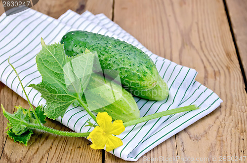 Image of Cucumber with flower and doily on the board