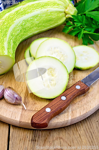 Image of Zucchini green with knife on board