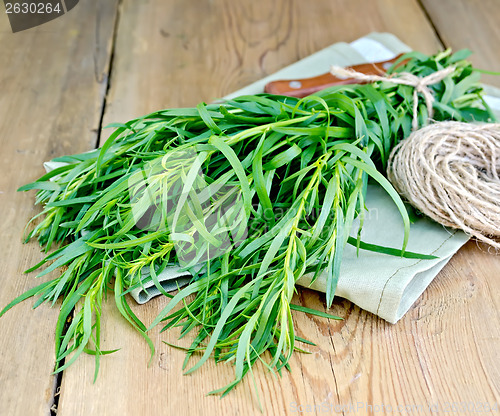 Image of Tarragon with a knife and twine on the board