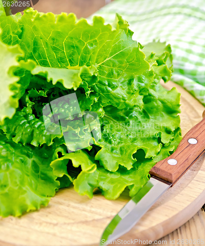 Image of Lettuce green with a knife on board