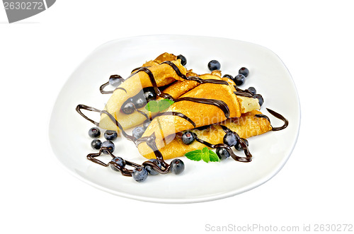 Image of Pancakes with blueberries and chocolate in a plate