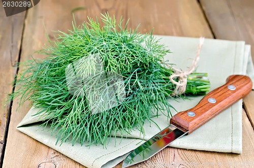 Image of Dill with knife and napkin on a blackboard