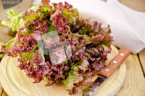 Image of Lettuce red with a knife on board
