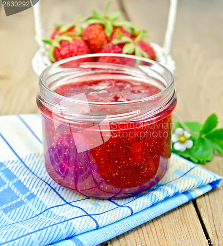 Image of Jam of strawberry with a basket on the board