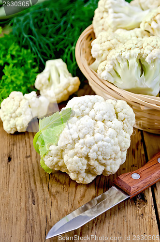 Image of Cauliflower with a basket and knife on board