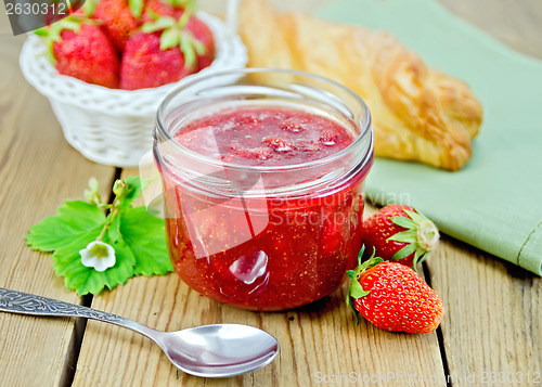 Image of Jam of strawberry with a bun on the board