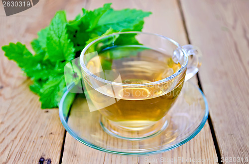 Image of Herbal tea with melissa on a wooden board