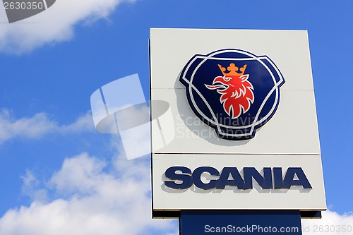 Image of Sign Scania against Blue Sky with Some Clouds