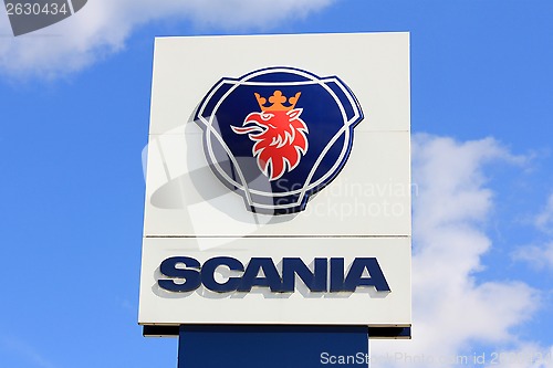 Image of Sign Scania against Blue Sky with Some Clouds