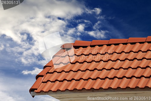Image of Roof tiles and sky with clouds at sunny day