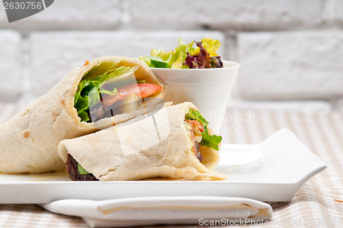 Image of kafta shawarma chicken pita wrap roll sandwich