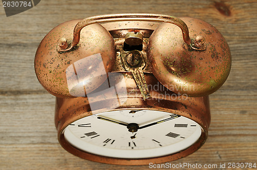 Image of old-fashioned vintage copper alarm clock