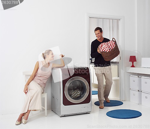 Image of woman and man doing laundry