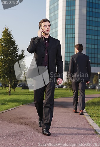 Image of Businessman walking near office a