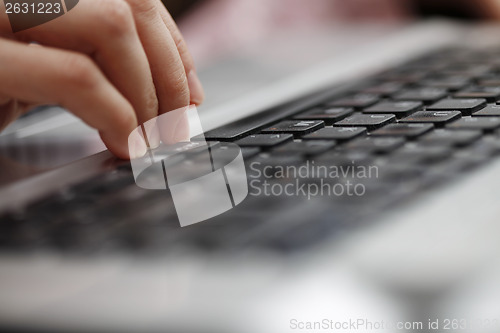 Image of Young woman working on laptop