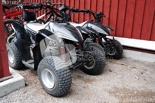 Image of two ATVs outdoor near the house