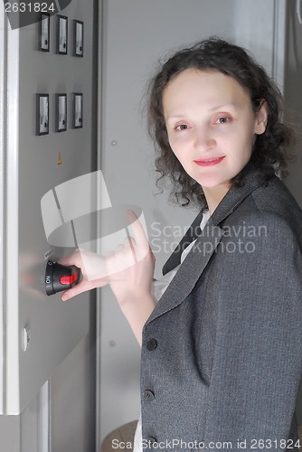 Image of Woman working on telecommunication equipment