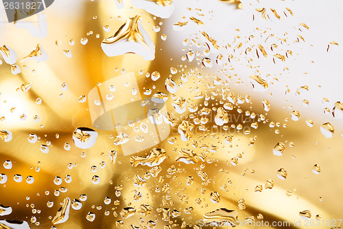 Image of golden abstract background with water drops