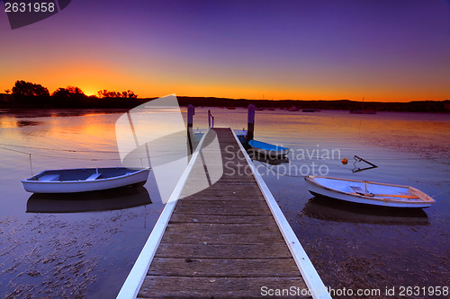 Image of Sunset moorings and boat jetty in a little cove Australia