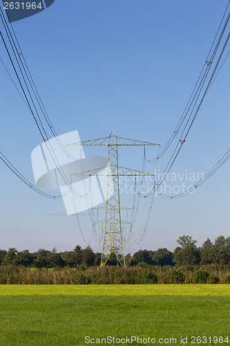 Image of Electric powerlines across a beautiful field
