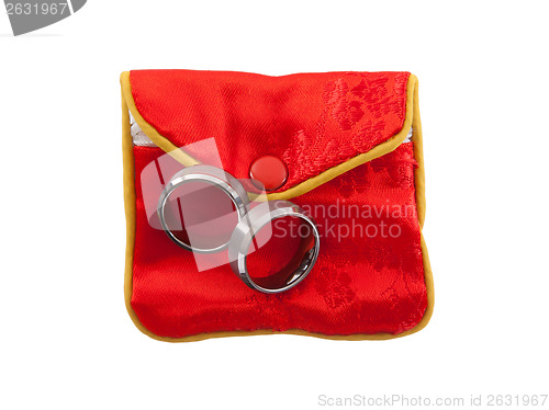 Image of Wedding rings on a red pouch