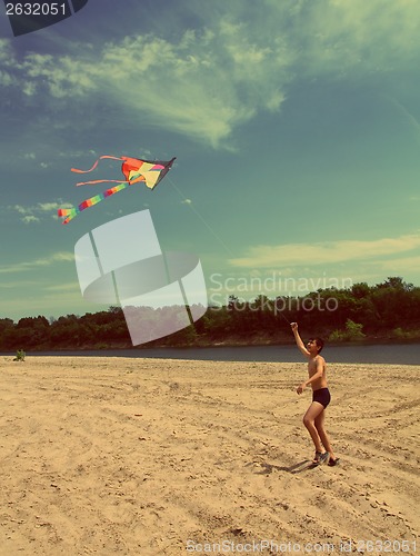 Image of asian boy running kite - vintage retro style