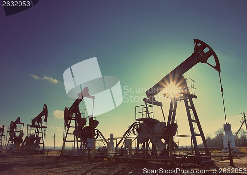 Image of working oil pumps silhouette - vintage retro style