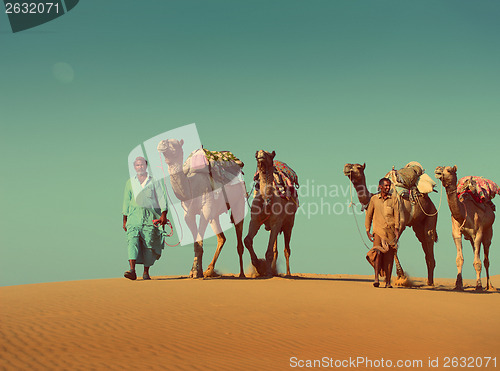 Image of cameleers with camels in desert  - vintage retro style