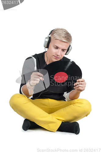 Image of Young man reading from vinyl record